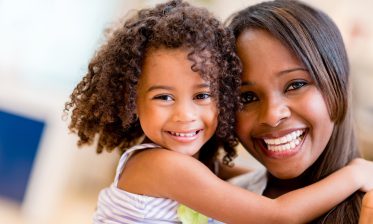 adoptive mother and daughter hugging